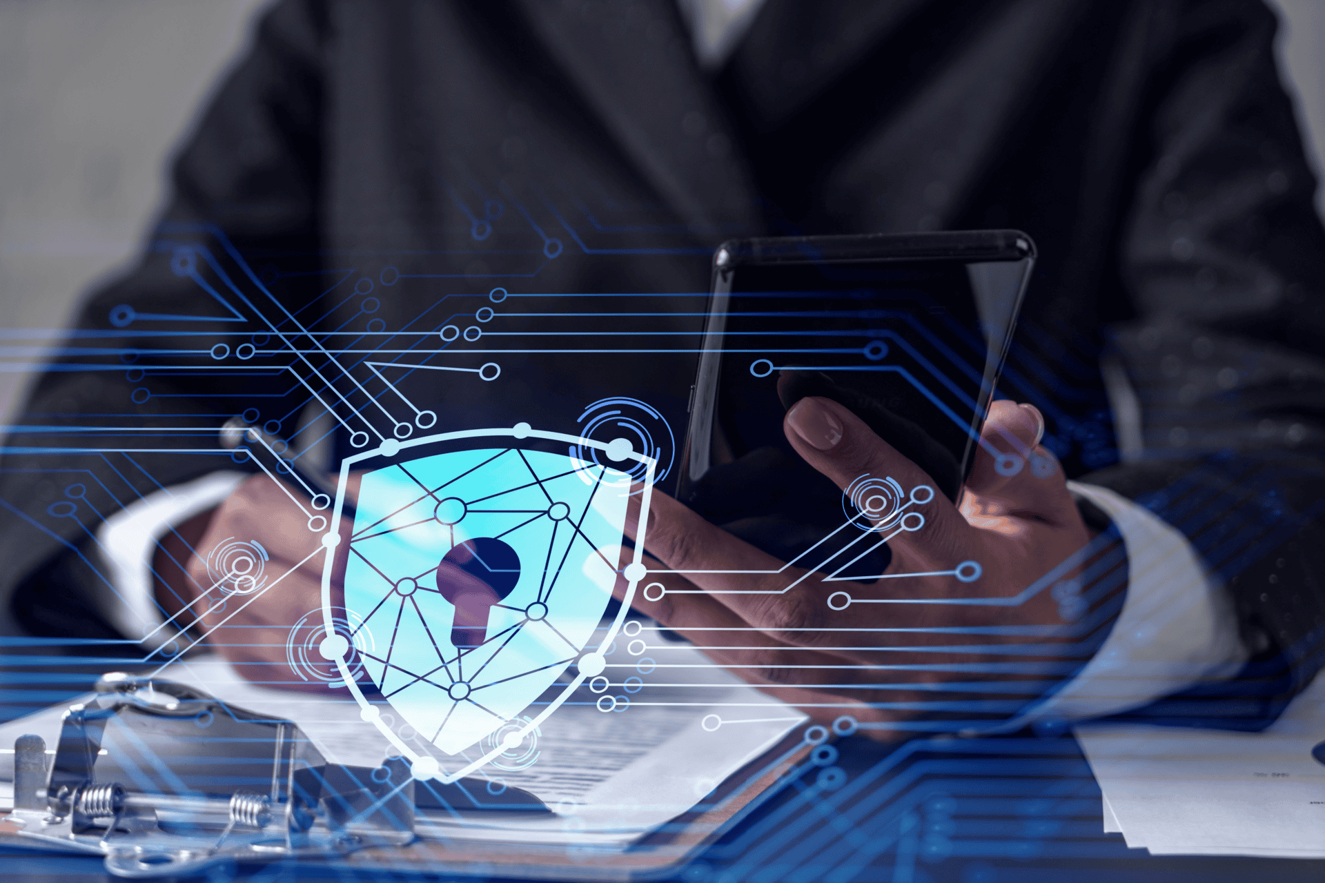 African American businesswoman in formal wear signing the contract to prevent probability of risks in cyber security. Checking the phone. Padlock Hologram icons over the working desk.